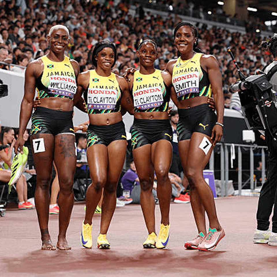 Jamaican women sprinters celebrating together.